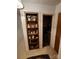 Hallway with built-in shelving for decor, and doorway view to a full bathroom at 406 S Caldwell Ave, Newton, NC 28658