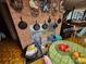 A view of a brick fireplace and kitchen featuring an electric range and table with fruit at 406 S Caldwell Ave, Newton, NC 28658