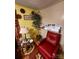 Living room with red chair, side table and tree, with pass through to kitchen at 406 S Caldwell Ave, Newton, NC 28658