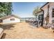 Backyard view of a lake house with a white storage shed, grey deck, and steps down to the yard at 451 S Strand Dr, Norwood, NC 28128