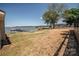 View of the backyard with a glimpse of the lake and boat dock at 451 S Strand Dr, Norwood, NC 28128