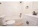 Bright bathroom featuring a shower-tub combo, modern vanity, and sleek, black fixtures at 451 S Strand Dr, Norwood, NC 28128