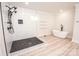 Luxurious bathroom with sleek shower, modern bathtub, and floating shelves for storage at 451 S Strand Dr, Norwood, NC 28128