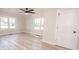 Spacious bedroom with hardwood flooring, neutral walls, and two windows for natural light at 451 S Strand Dr, Norwood, NC 28128