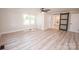Large bedroom features light wood floors, a ceiling fan, and a view of the ensuite bath at 451 S Strand Dr, Norwood, NC 28128