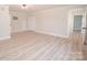 Bedroom boasts wood-look flooring, neutral paint, and ample closet space at 451 S Strand Dr, Norwood, NC 28128