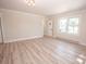 Spacious bedroom with wood-look flooring, neutral paint, and bright windows at 451 S Strand Dr, Norwood, NC 28128