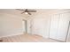 This bedroom features light wood floors, a ceiling fan, crown molding, and a closet for ample storage at 451 S Strand Dr, Norwood, NC 28128
