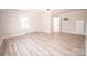 Bedroom boasts wood flooring, neutral paint, and bright windows at 451 S Strand Dr, Norwood, NC 28128