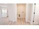 Walk-in closet with light wood floors, an electrical outlet, and neutral colored walls at 451 S Strand Dr, Norwood, NC 28128
