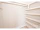 Walk-in closet with modern built-in shelving and wood flooring at 451 S Strand Dr, Norwood, NC 28128