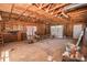 Unfinished garage interior with exposed wood ceiling, concrete floor, and garage door at 451 S Strand Dr, Norwood, NC 28128