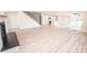 Open-concept living room with fireplace, staircase, and seamless flow into the modern kitchen at 451 S Strand Dr, Norwood, NC 28128