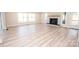 Spacious living room with a fireplace and large windows offering scenic outdoor views at 451 S Strand Dr, Norwood, NC 28128