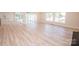 Bright and airy living room features luxury vinyl flooring and access to the back deck at 451 S Strand Dr, Norwood, NC 28128