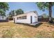 Exterior view of the shed featuring a painted door, windows, and simple gable roof at 451 S Strand Dr, Norwood, NC 28128