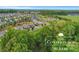 The Conservancy McLean community with winding roads, lush greenery, and beautiful single-Gathering homes from an aerial view at 504 Gardenbrook Trl, Belmont, NC 28012
