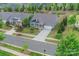 An aerial view of a well-manicured property with a two-car garage, lush greenery, and a landscaped lawn at 504 Gardenbrook Trl, Belmont, NC 28012
