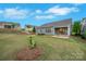 Beautifully landscaped backyard with a well-maintained lawn and patio with view of the home's exterior at 504 Gardenbrook Trl, Belmont, NC 28012