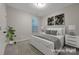 Cozy bedroom with a queen bed, side tables, neutral colored paint, and plant accents at 504 Gardenbrook Trl, Belmont, NC 28012