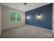 Inviting bedroom with a large window and an accent wall with sconce lighting at 504 Gardenbrook Trl, Belmont, NC 28012