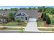 Charming single-Gathering home featuring a stone facade, two-car garage, and a beautifully landscaped front yard at 504 Gardenbrook Trl, Belmont, NC 28012