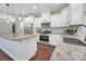 Spacious modern kitchen featuring granite countertops, stainless steel appliances, and a central island at 504 Gardenbrook Trl, Belmont, NC 28012