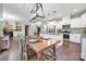 Modern eat-in kitchen features granite countertops, stainless appliances, and pendant lighting open to the living room at 504 Gardenbrook Trl, Belmont, NC 28012