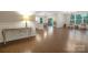 Bright open-concept living room featuring hardwood floors, modern lighting, and large windows with ample natural light at 504 Gardenbrook Trl, Belmont, NC 28012