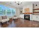 Inviting living room with a cozy fireplace, hardwood floors, and stylish seating at 504 Gardenbrook Trl, Belmont, NC 28012