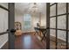 Stylish home office featuring dark wood floors, decorative wallpaper, and ample natural light at 504 Gardenbrook Trl, Belmont, NC 28012