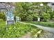Marked trailhead amidst lush greenery, inviting residents to explore scenic nature trails at 504 Gardenbrook Trl, Belmont, NC 28012