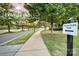 Scenic community walking path shaded by mature trees, providing a peaceful outdoor experience at 504 Gardenbrook Trl, Belmont, NC 28012
