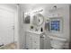 Cozy bathroom featuring a round mirror and a white single sink vanity at 505 N Graham St # 2H, Charlotte, NC 28202
