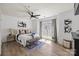 Bright bedroom with ample natural light, a ceiling fan, wood floors, and tasteful decor at 505 N Graham St # 2H, Charlotte, NC 28202