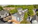 Apartment building featuring neutral siding, dark gray roof, and parking at 505 N Graham St # 2H, Charlotte, NC 28202