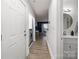 Hallway view including bathroom and laundry nook; features modern lighting and wood-look flooring at 505 N Graham St # 2H, Charlotte, NC 28202