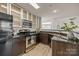 Updated kitchen boasts stainless steel appliances, dark cabinetry, granite counters, and modern fixtures at 505 N Graham St # 2H, Charlotte, NC 28202