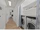 Convenient laundry area with washer, dryer, and storage shelves along the hallway at 505 N Graham St # 2H, Charlotte, NC 28202