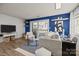 Bright living room with modern furniture, blue accent wall, balcony access, and contemporary decor at 505 N Graham St # 2H, Charlotte, NC 28202