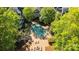 Aerial view of the pool surrounded by trees, lounge chairs, and brick pavers at 505 N Graham St # 2H, Charlotte, NC 28202