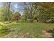 View of a lush, green backyard with mature trees and landscaped features at 505 S South St, Gastonia, NC 28052