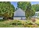 The backyard reveals construction, surrounded by lush trees and a serene pond at 505 S South St, Gastonia, NC 28052