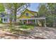 Inviting yellow home featuring a covered carport, complementing the home's classic style at 505 S South St, Gastonia, NC 28052