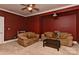 Comfortable living room with matching sofas, dark table and ceiling fan at 505 S South St, Gastonia, NC 28052