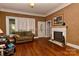 Cozy living room with hardwood floors, a decorative fireplace, and ample natural light at 505 S South St, Gastonia, NC 28052