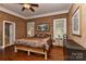 Comfortable main bedroom boasts a ceiling fan, a large bed, and hardwood floors at 505 S South St, Gastonia, NC 28052