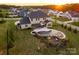 Aerial view of the backyard featuring a custom pool with waterfall, spa, and covered patio with outdoor seating at 5051 Hyannis Ct, Matthews, NC 28104