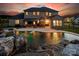 Expansive backyard featuring a pool with rock waterfall and covered patio with dining area, perfect for entertaining at 5051 Hyannis Ct, Matthews, NC 28104