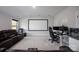 Basement features a projector screen and seating, a gaming setup, and neutral decor at 5051 Hyannis Ct, Matthews, NC 28104